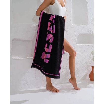 Enjoy the sun and sand with this playful "Reserved" towel.